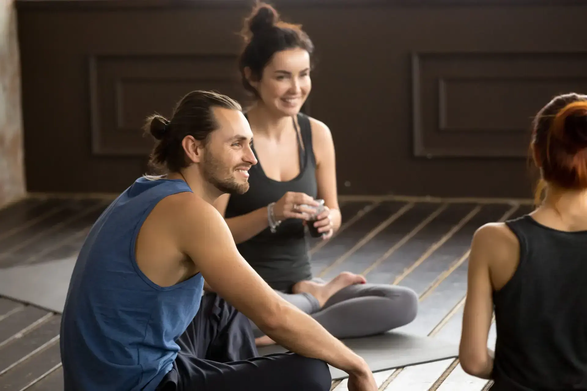 A couple and facilitator talking together during a couples workshop