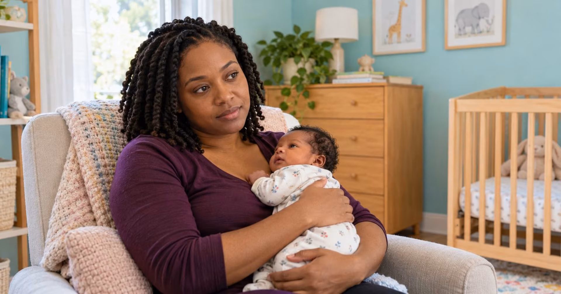 New mother holding her newborn during a quiet moment in the postpartum period.