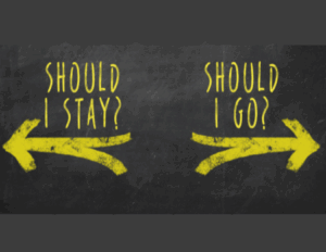 A chalkboard displays two yellow arrows pointing in opposite directions, illustrating a couple’s dilemma with the text "Should I Stay?" on the left and "Should I Go?" on the right—a common crossroads in Discernment Counseling before divorce.