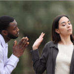 A man with clasped hands appears to plead with a woman who turns away and raises her hand dismissively, highlighting the complexities of relationships and the subtlety of dry begging or indirect requests.