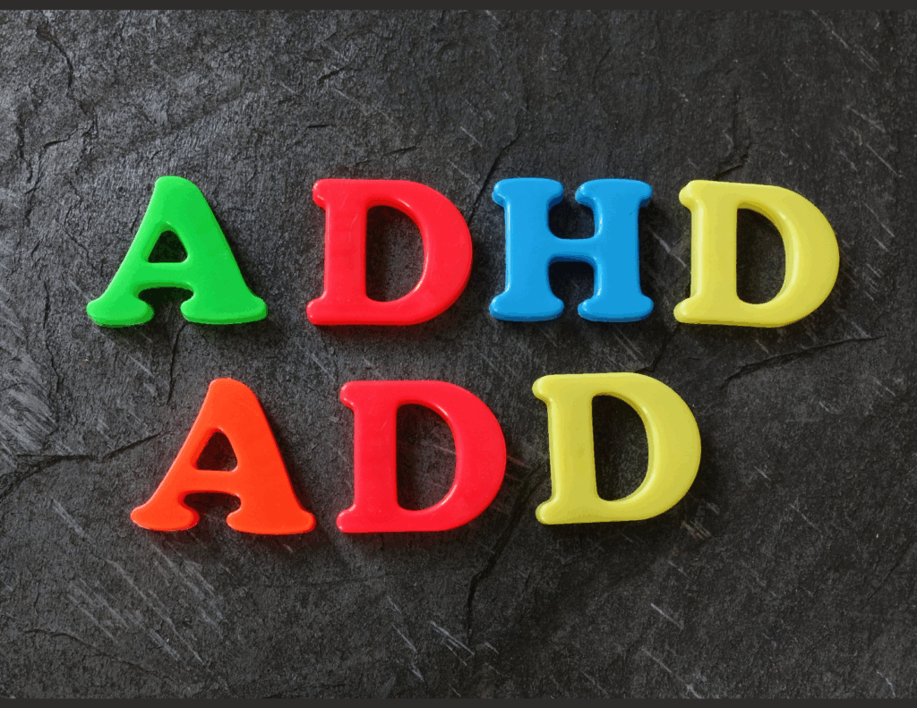 Plastic letters spelling "ADHD" and "ADD" arranged on a dark textured surface, highlighting awareness and treatment options for these conditions.