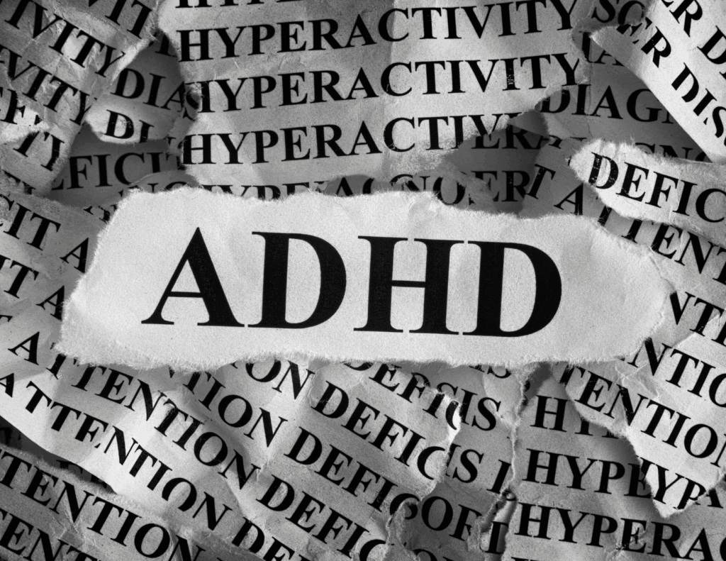 A torn paper displaying "ADHD" in bold letters, layered over repeated words like "HYPERACTIVITY" and "ATTENTION DEFICIT" in the background, highlights the need for ADHD support and essential ADHD skills.