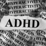 A torn paper displaying "ADHD" in bold letters, layered over repeated words like "HYPERACTIVITY" and "ATTENTION DEFICIT" in the background, highlights the need for ADHD support and essential ADHD skills.