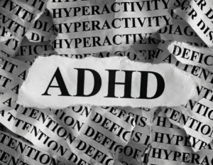 A torn paper displaying "ADHD" in bold letters, layered over repeated words like "HYPERACTIVITY" and "ATTENTION DEFICIT" in the background, highlights the need for ADHD support and essential ADHD skills.