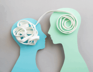 Two silhouette cutouts face each other; a tangled white cord is inside one head and a neatly coiled cord leads to the other, symbolizing how empathy can untangle thoughts and foster clearer communication or knowledge transfer.
